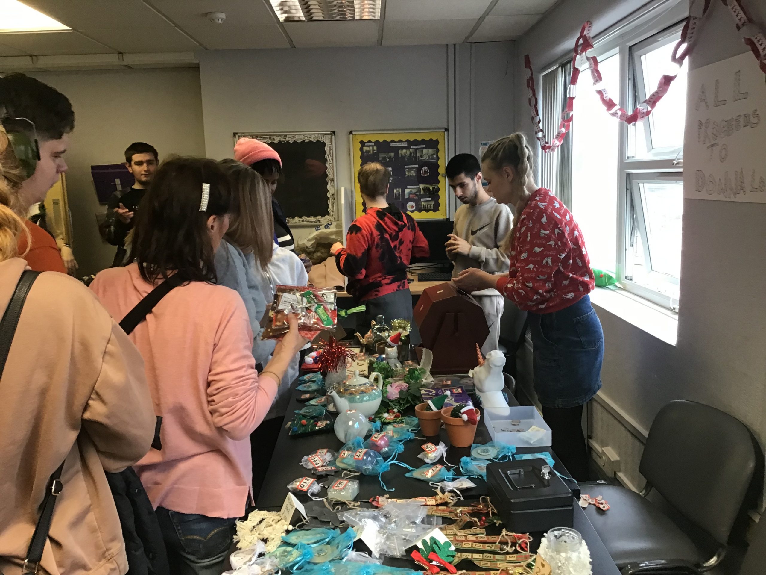 People browsing a crafts table at Regent College fair