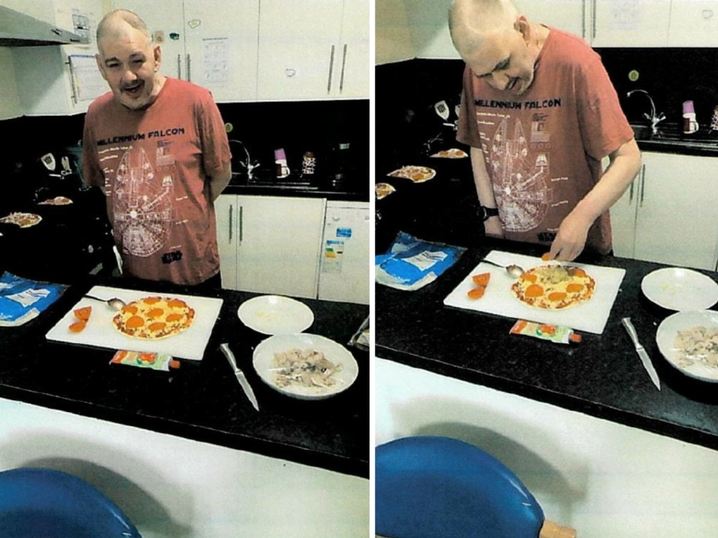 A person in a kitchen preparing a pizza