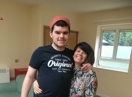 A man stood with his arm around his mum
