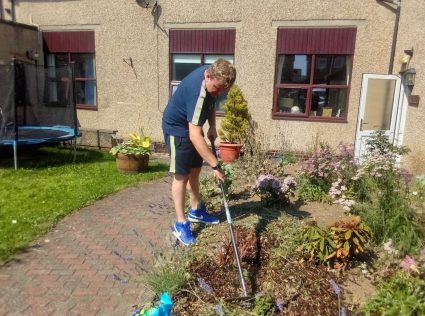 A man raking a garden
