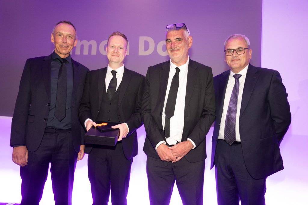 Four men stood together in suits