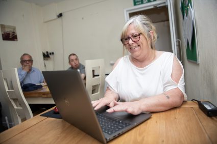 A woman typing on a laptop