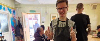 A man stood next to three plates of food