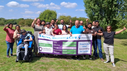 A group of people holding a banner and celebrating