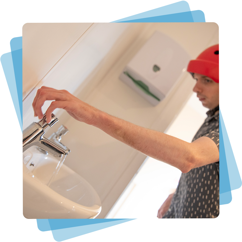 A man turning on a tap