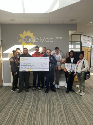A group of people holding a big cheque