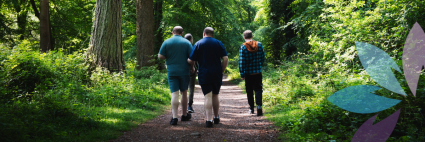 three people walking through a wood